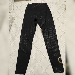 CycleBar XSmall Glyder black leggings with shiny print and gold CB logo